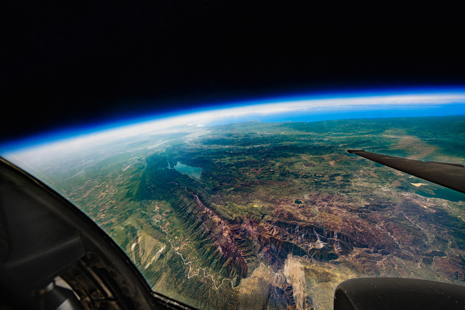 A mountain range seen from the cockpit of a U2 over 70,000 feet from the Earth